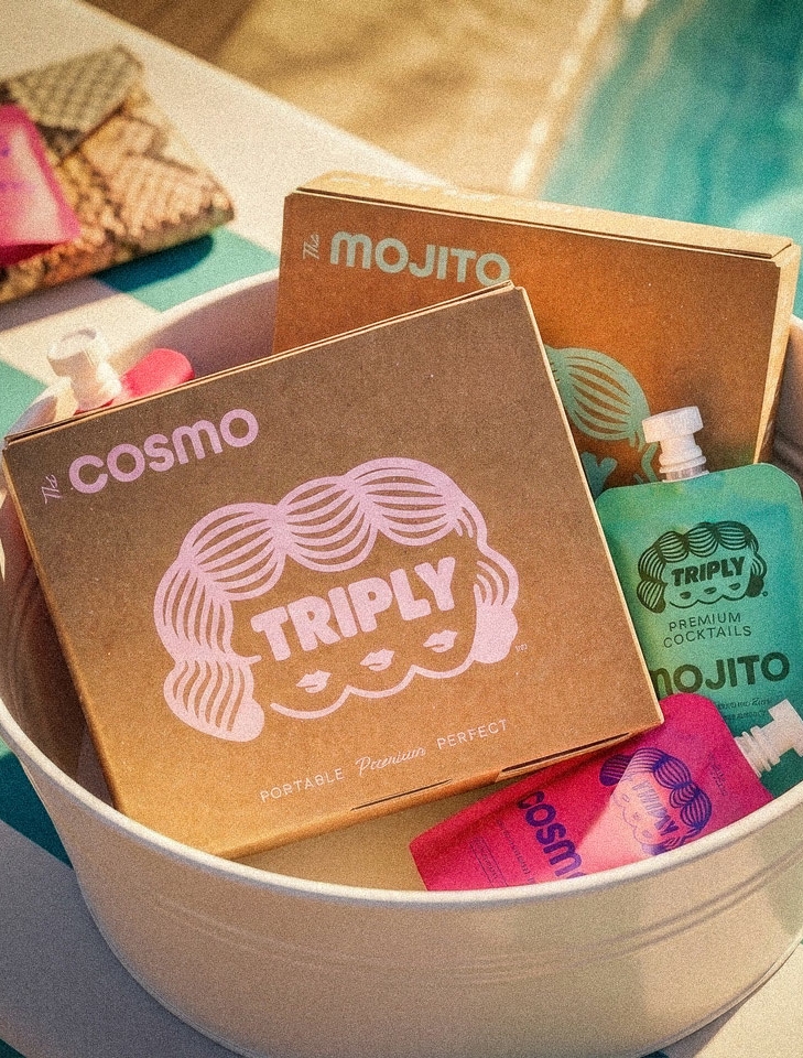 Triply cocktail boxes and pouches beside a pool