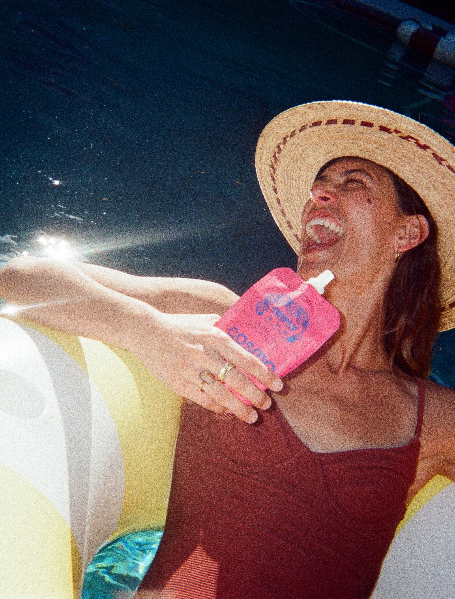 A woman enjoying Triply cocktails by the pool