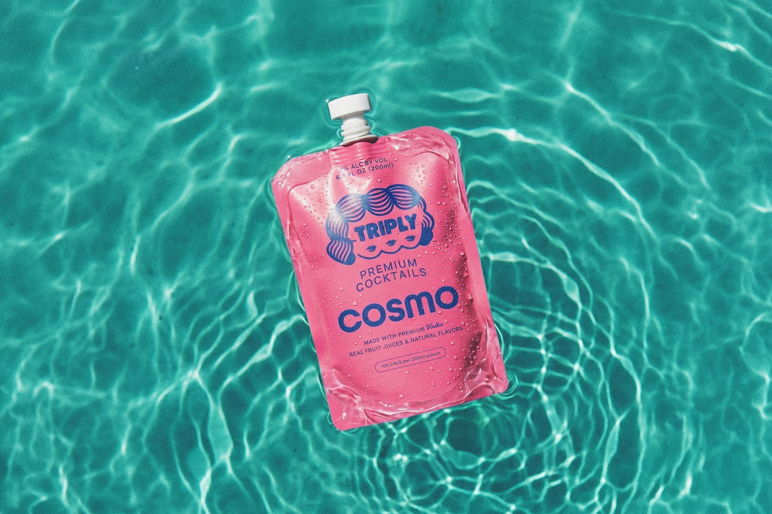 Cosmo pouch floating in a pool